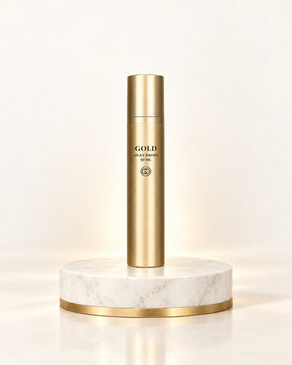 GOLD Haircare Silky Drops 50 ml in goldener Flasche auf weißem Marmorpodest mit Goldrand
